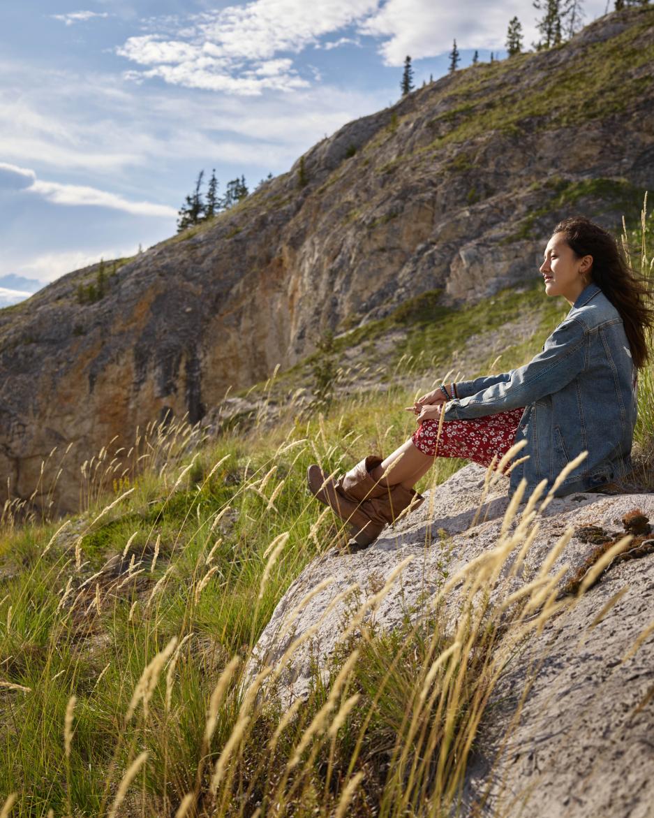 Shalaya Blackjack sitting hillside in Carmacks