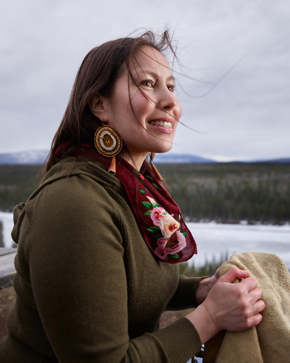 Geri-lee holding moose hide while smiling. 
