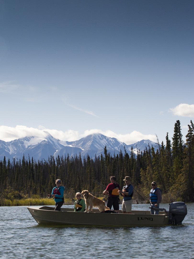 A group fishes from a boat on Pine Lake