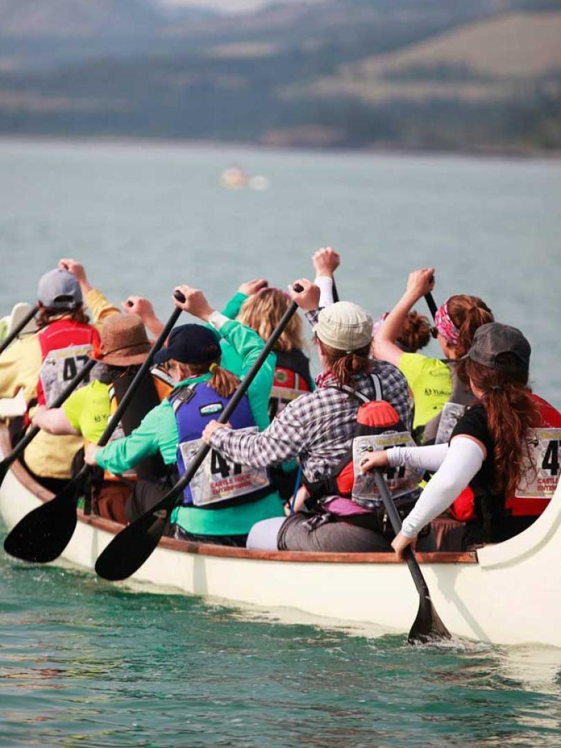 A canoe full of paddlers makes its way down the river