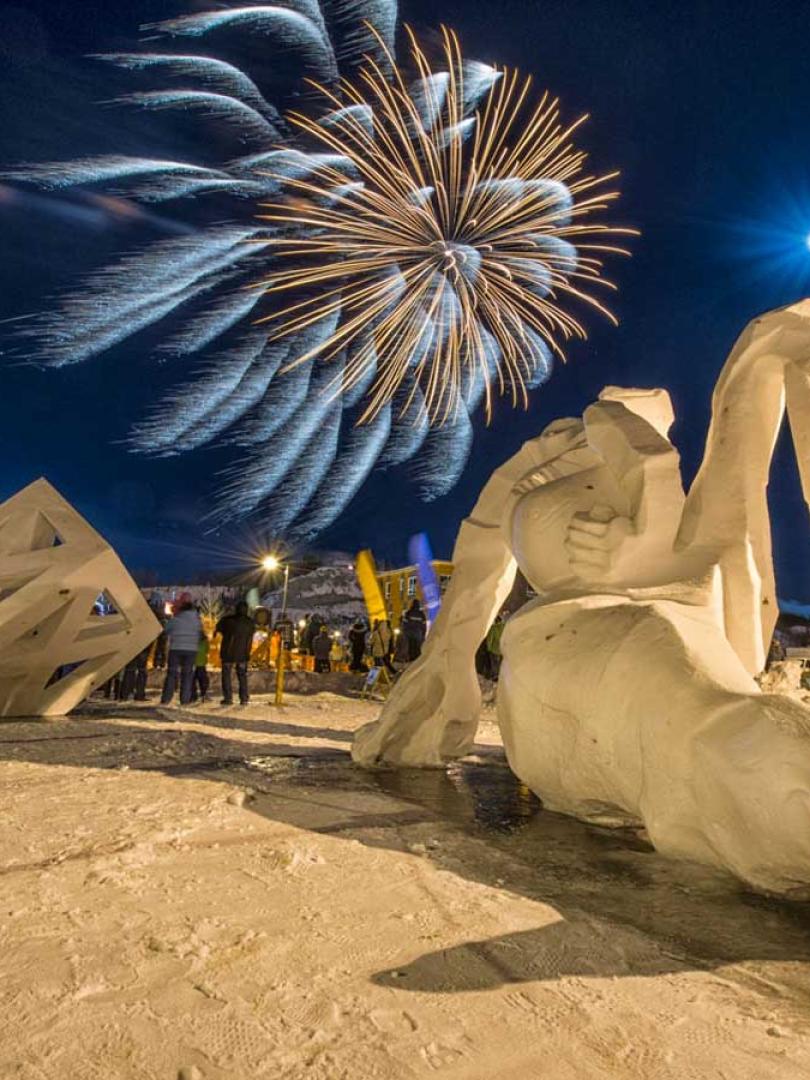Fireworks burst over snow sculptures of the Yukon Rendezvous Festival