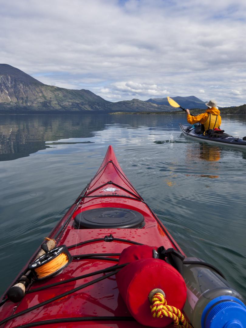 Kayaking across a lake in summer