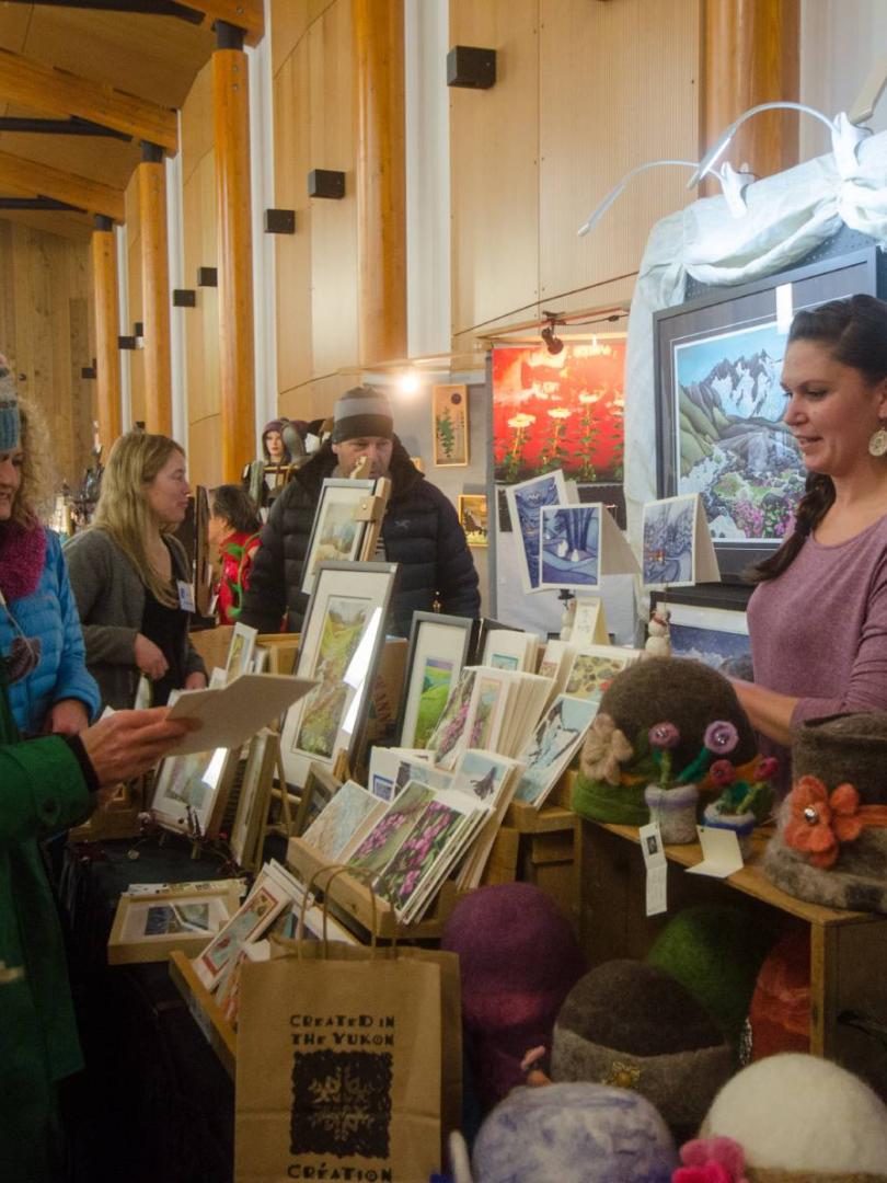 shoppers gather around a booth at a christmas market