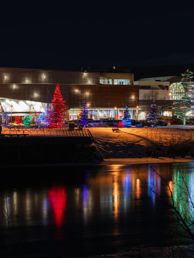 Christmas lights reflect in the Yukon River