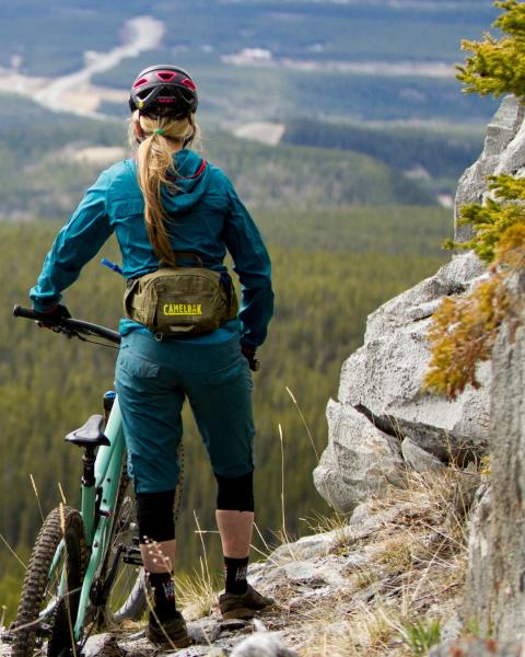 woman overlooks viewpoint next to bike