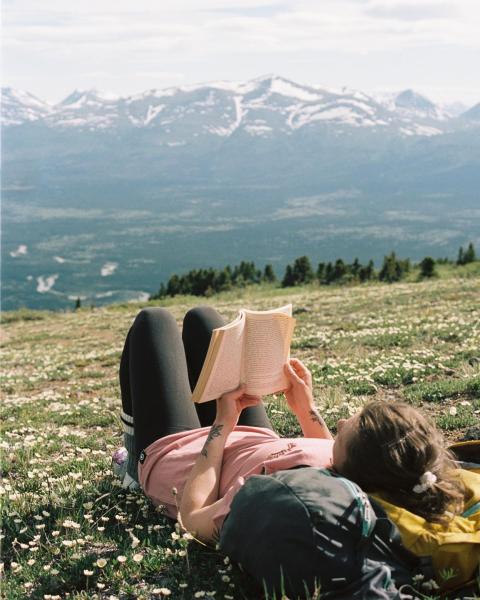 Woman reading on a mountaintop