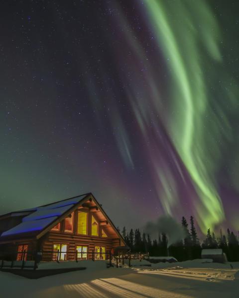 Aurora borealis shines above Northern Lights Resort and Spa