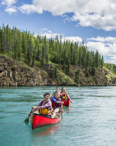 Paddlers enjoy a canoe ride through Miles Canyon