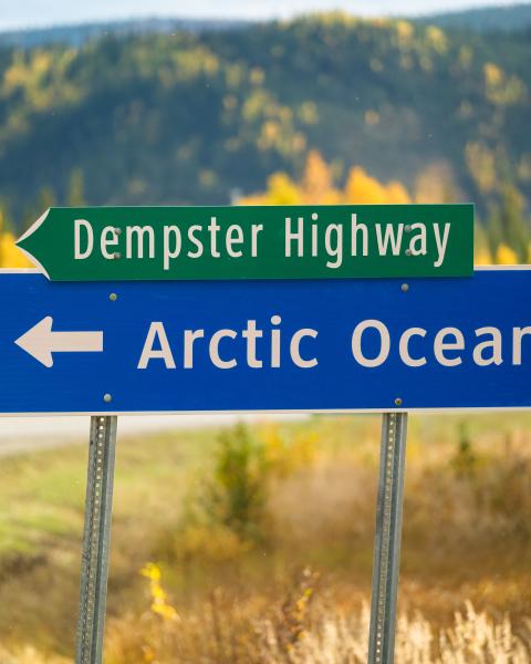 A sign on highway indicating arctic ocean 