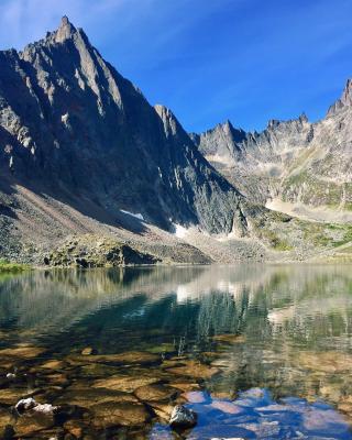 Mount monolith in front of a crystal clear lake