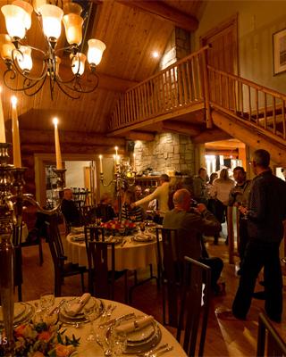 People gathering in the foyer of a wood cabin