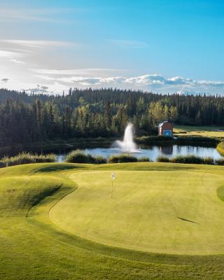 A green golf course on a blue sky day
