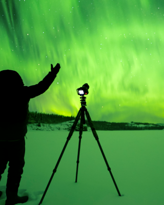 Person looking at aurora in front of camera