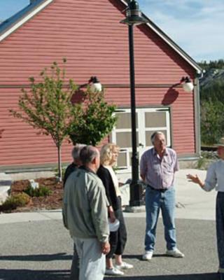 People stand in front of a museum on an interpretive tour
