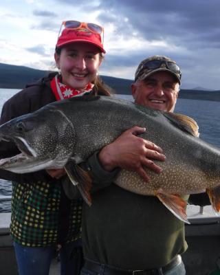 Two people hold a giant fish