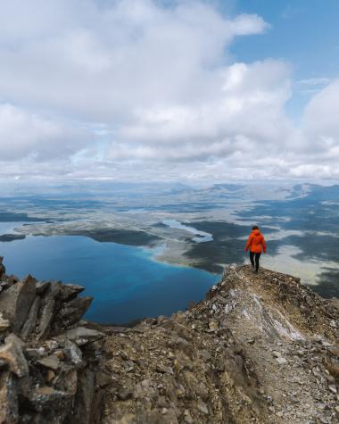 A hiker enjoys the view at the top of King's Throne in Kluane National Park and Reserve