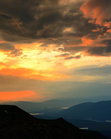 The sun sets over Keno from the top of Keno Hill sign post