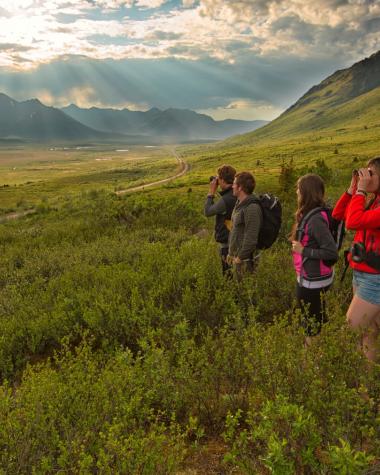 A group of friends look out at the views of Tombstone Territorial Park
