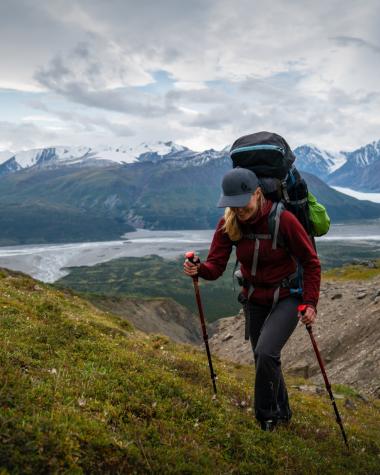 A hiker a mountain range above Primrose Lake in southern Yukon.