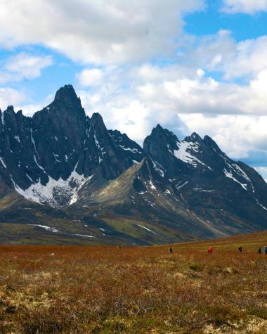 Tombstone Territorial Park mountains stand tall against the red and orange brush of fall