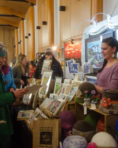 shoppers gather around a booth at a christmas market