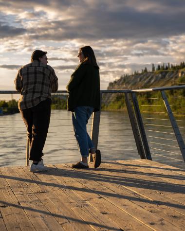 A couple enjoys the midnight sun along the Yukon River