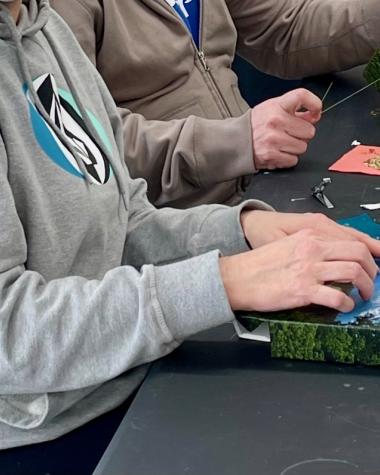 participants bead photos in a workshop with Pat Bragg