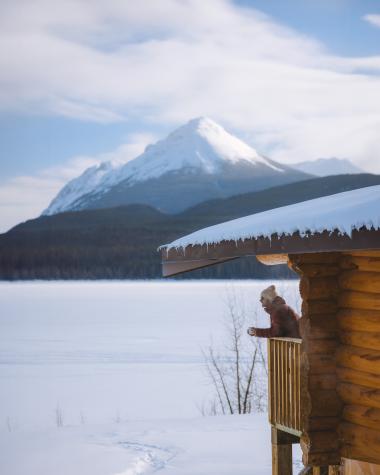 A person drinking coffee at Southern Lakes Cabin in winter. 