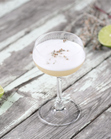 A frothy cocktail on a picnic table